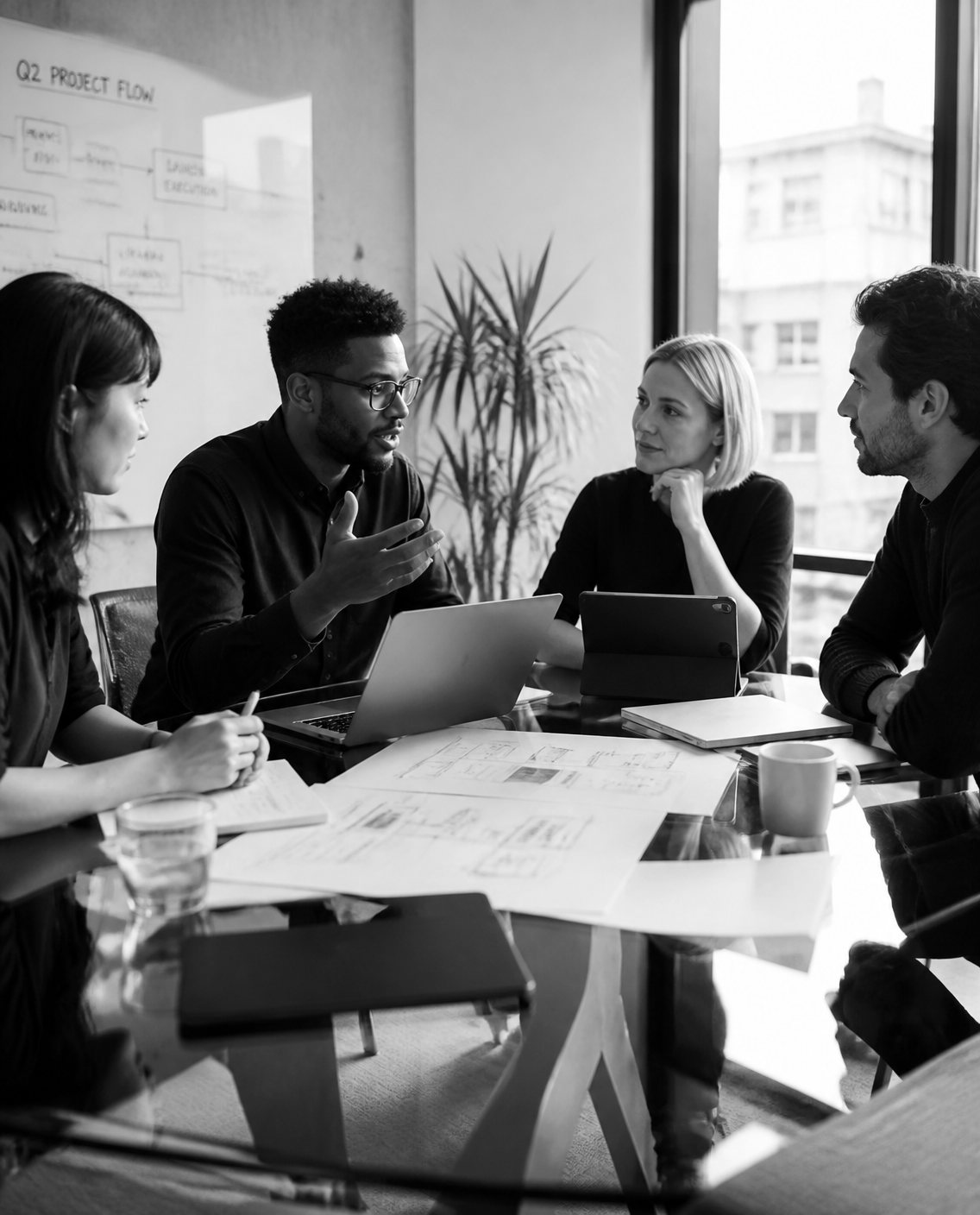 Business team discussing a project flow around a meeting table
